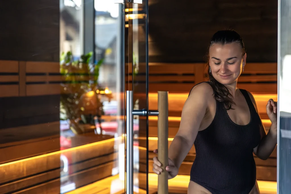 Woman enjoying a revitalizing sauna experience at Sisu Longevity Studio.