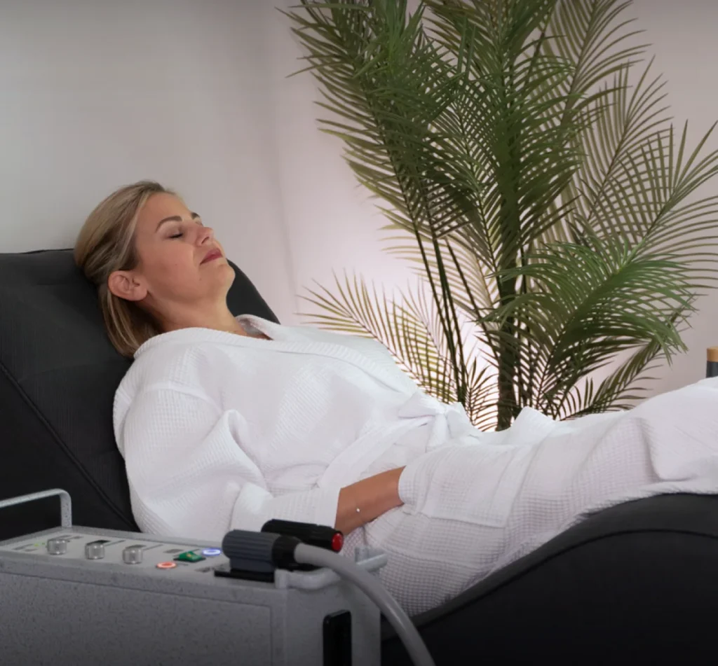 Person resting on a Pulse XL Pro PEMF therapy mat at Sisu Longevity Studio in Colorado Springs