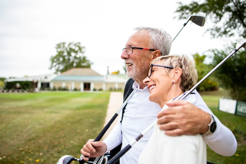 Older couple enjoying a round of golf, embodying wellness and vitality.