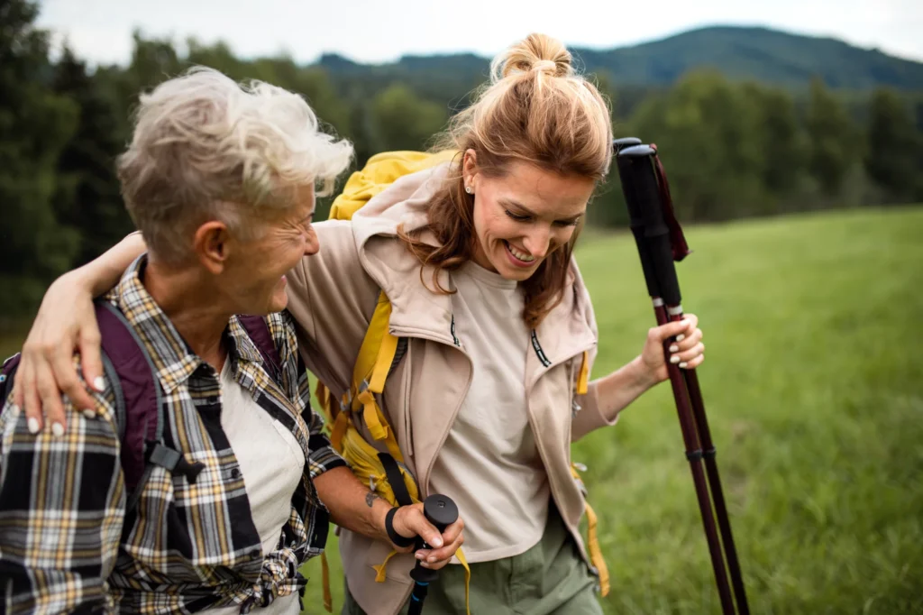 Older adult hiking with grandchild — the Sisu Strongest Decade goal of staying active at 80