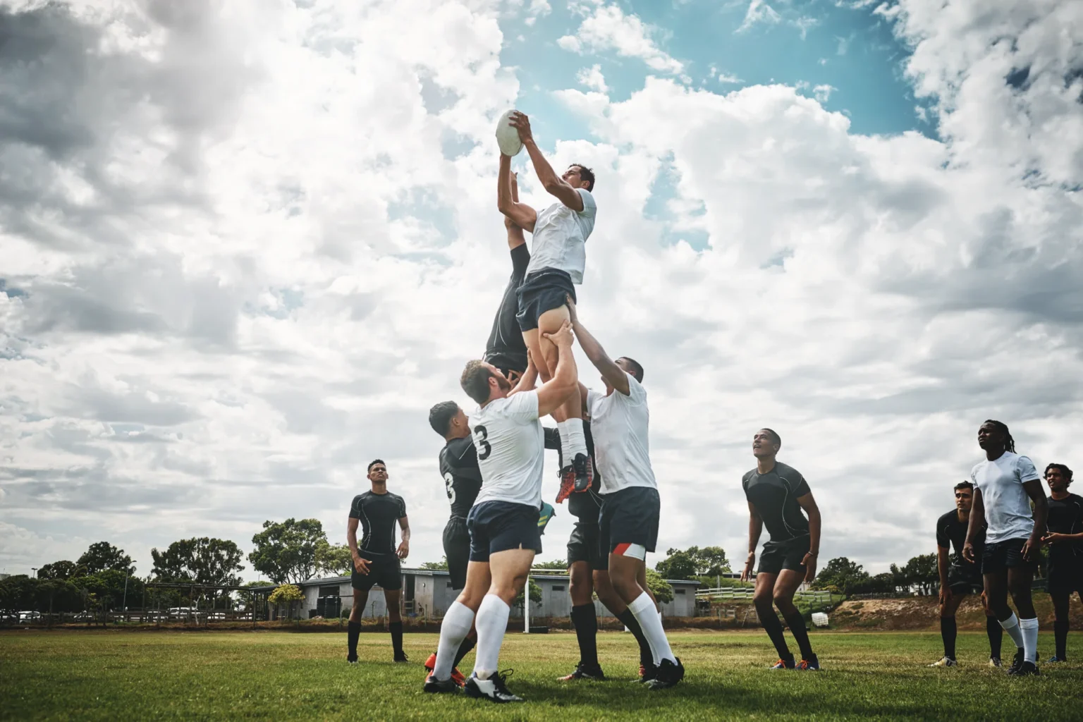 Rugby players demonstrating teamwork and energy on the field.