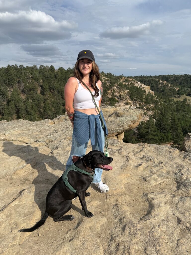 Woman and her dog enjoying a scenic mountainous hike, embodying energy and wellness.