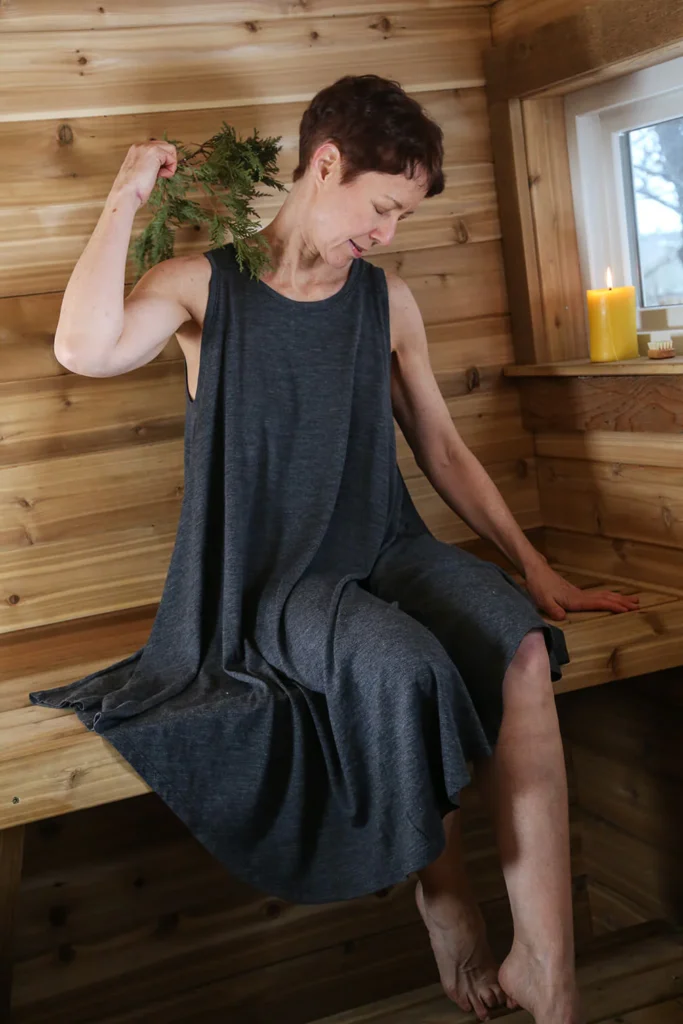 Woman relaxing in a sauna, embracing wellness and longevity.