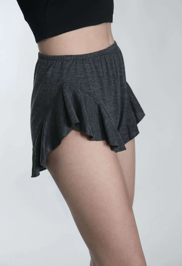 Person wearing comfortable gray shorts for wellness activities.