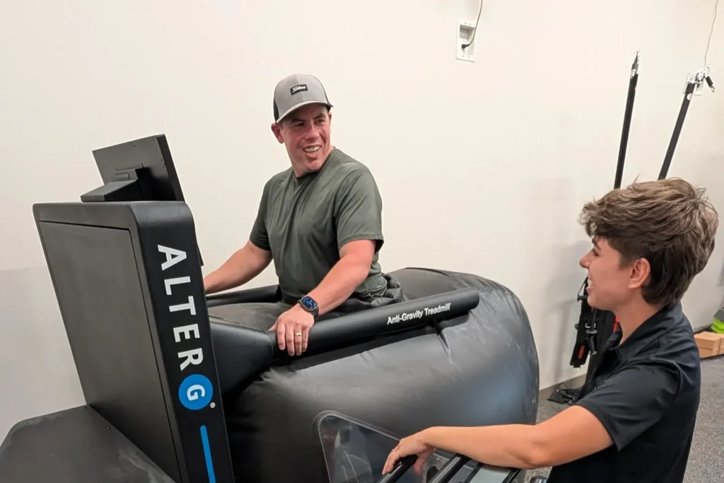 Coach working with a client on the AlterG Anti-Gravity Treadmill at Sisu Longevity Studio